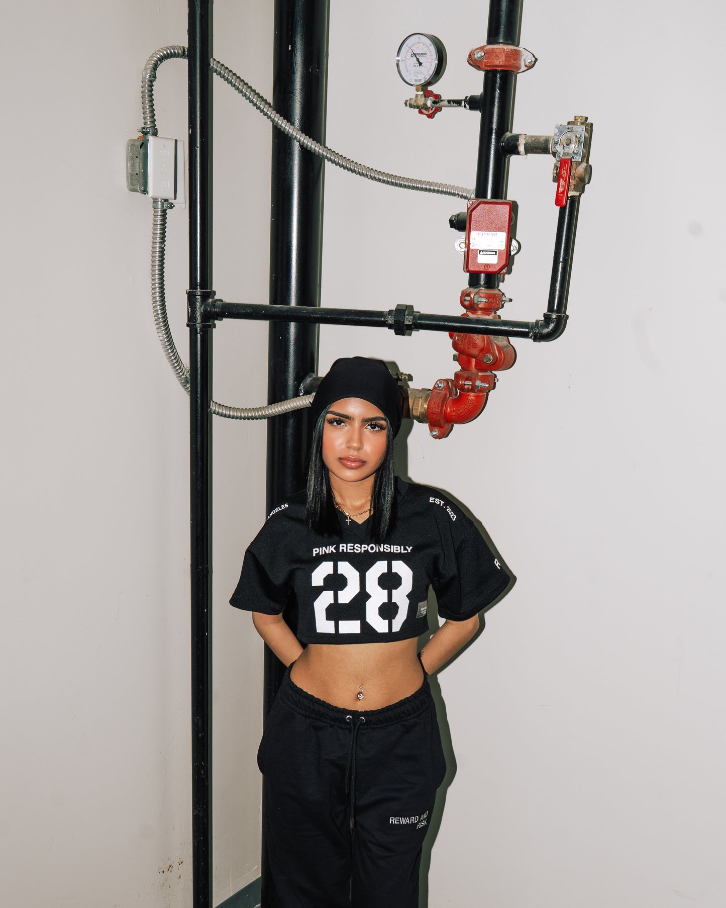 reward + risk cropped varsity jersey in black [women's]