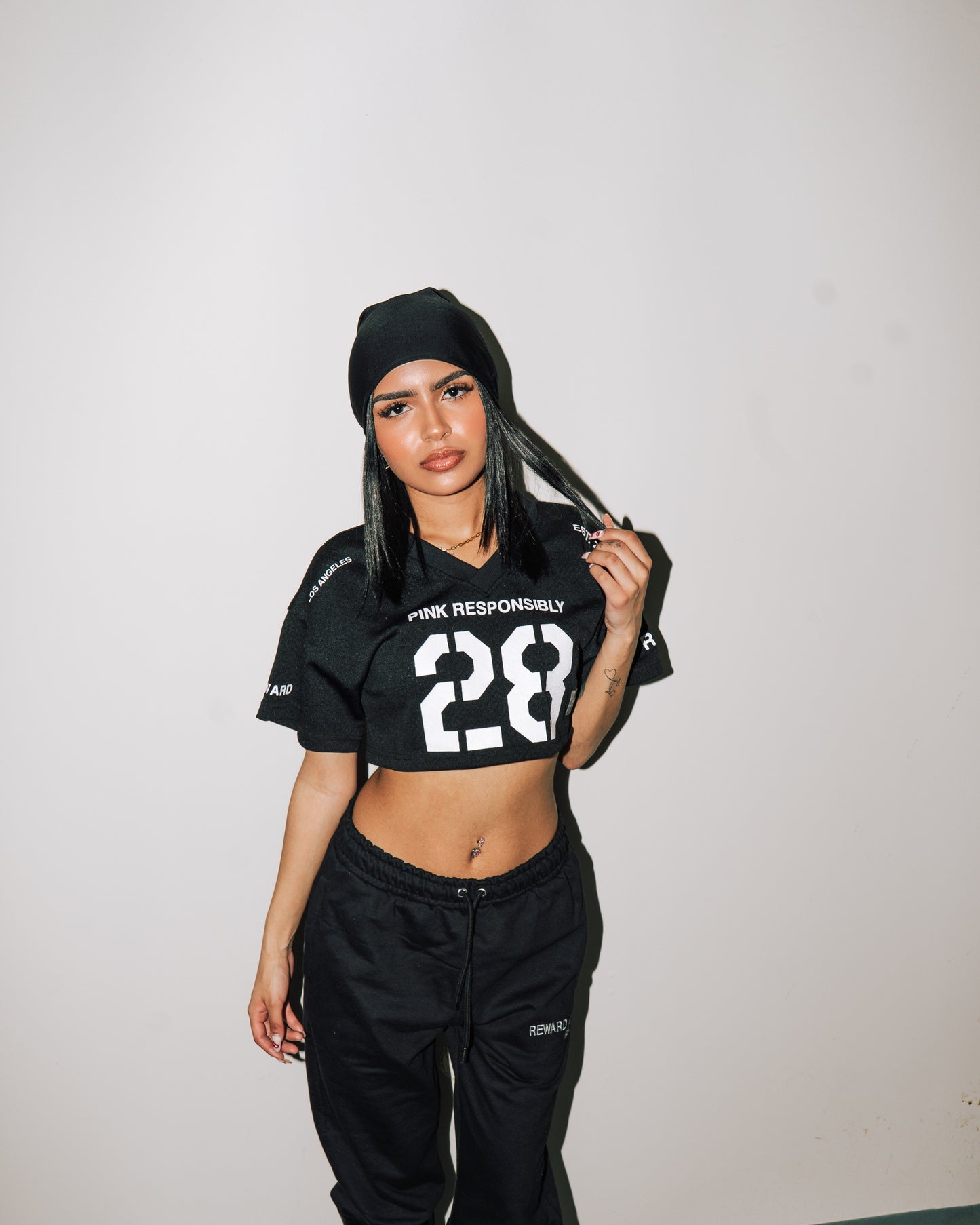 reward + risk cropped varsity jersey in black [women's]