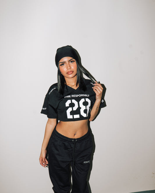 reward + risk cropped varsity jersey in black [women's]