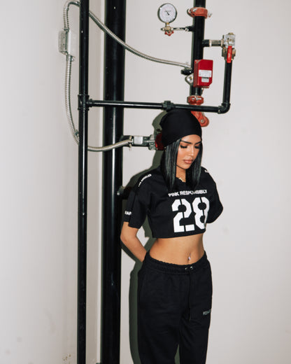 reward + risk cropped varsity jersey in black [women's]